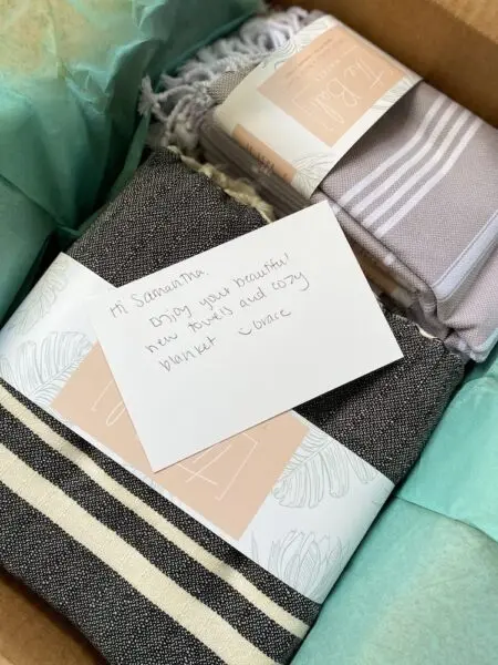 Image shows an opened package from Turkish towel brand The Bali Market, featuring a handwritten note.